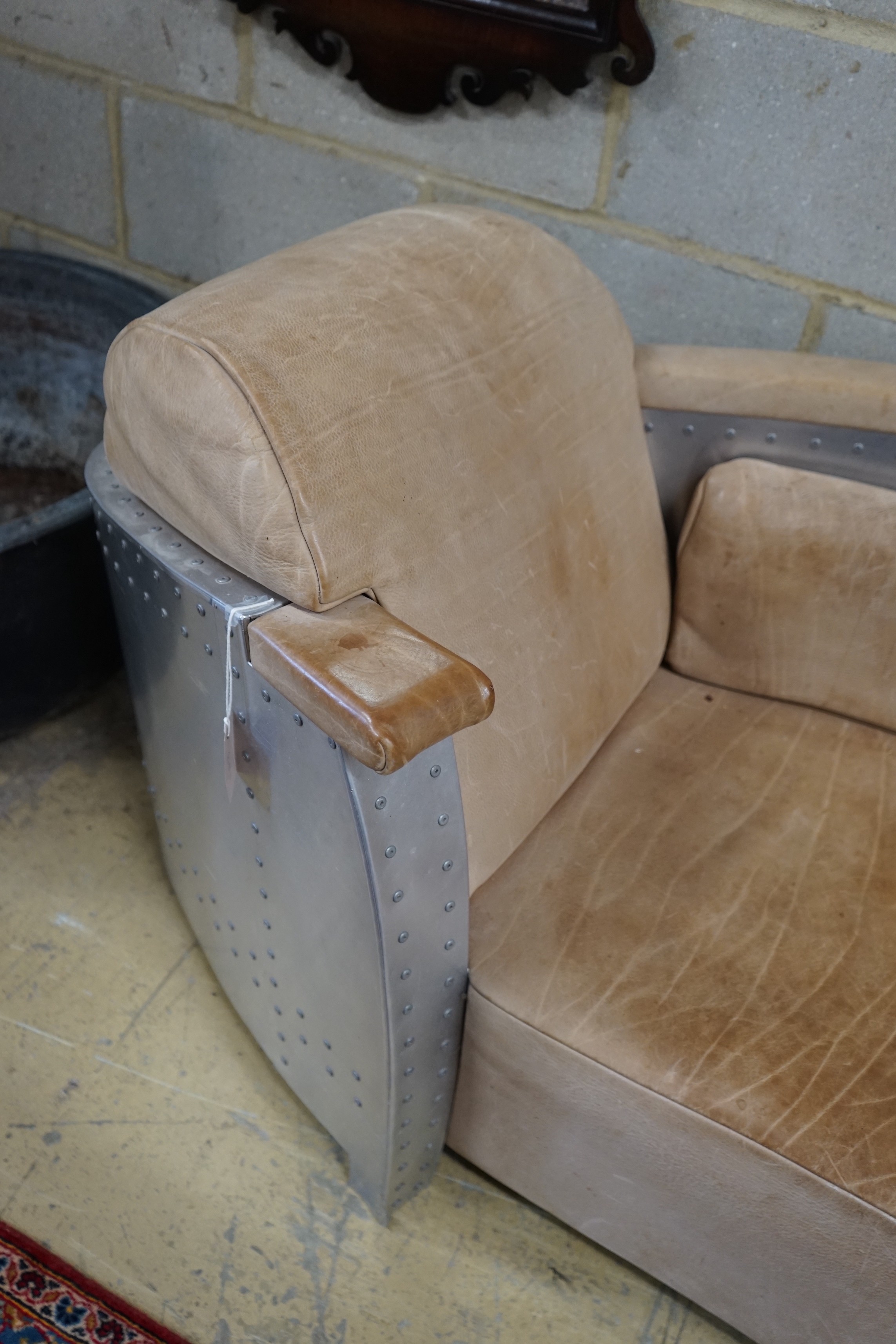A Timothy Oulton style aluminium and pale brown leather 'Aviator' day bed, length 200cm, width 76cm, height 77cm